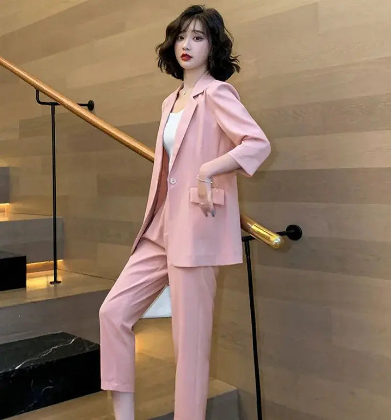 Model wearing the Command the Room green blazer and pants set in a professional setting.