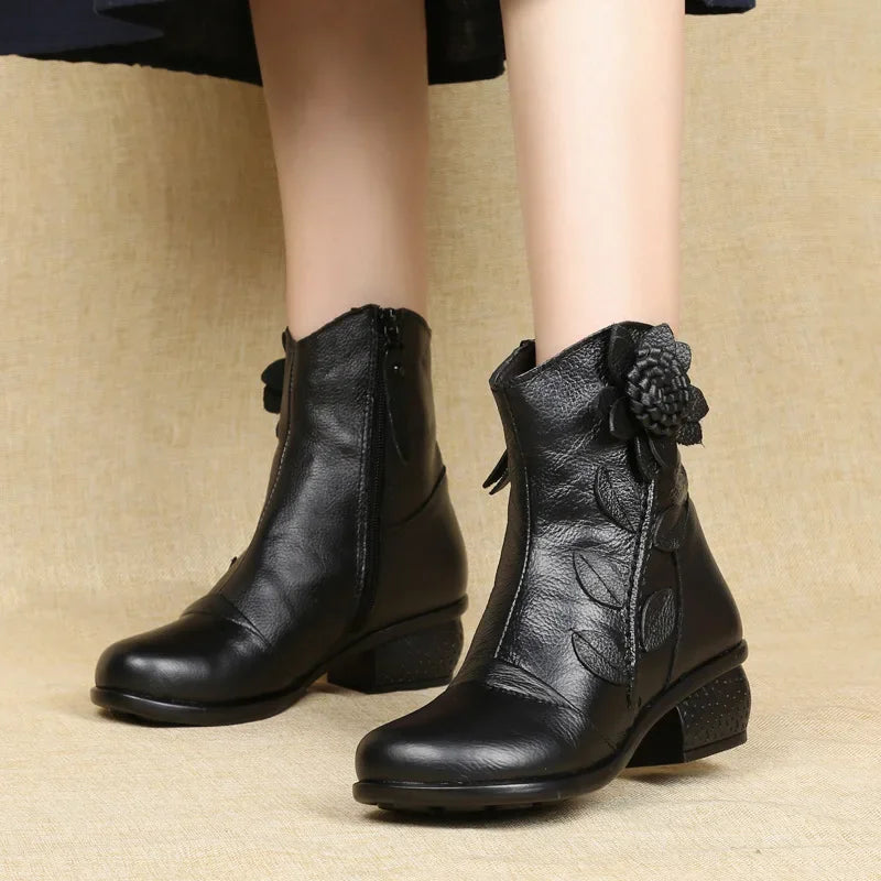 Mid-calf boots with delicate bloom artistry, side zip, and all-weather protection