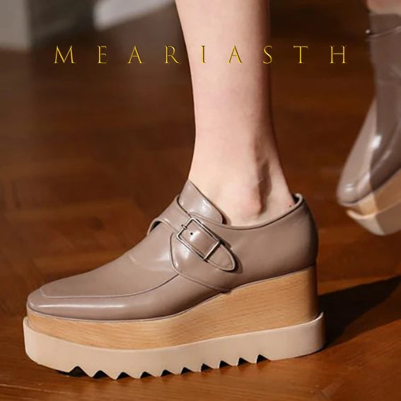 Side view of leather wedge sneakers showing hidden platform heel and sleek silhouette