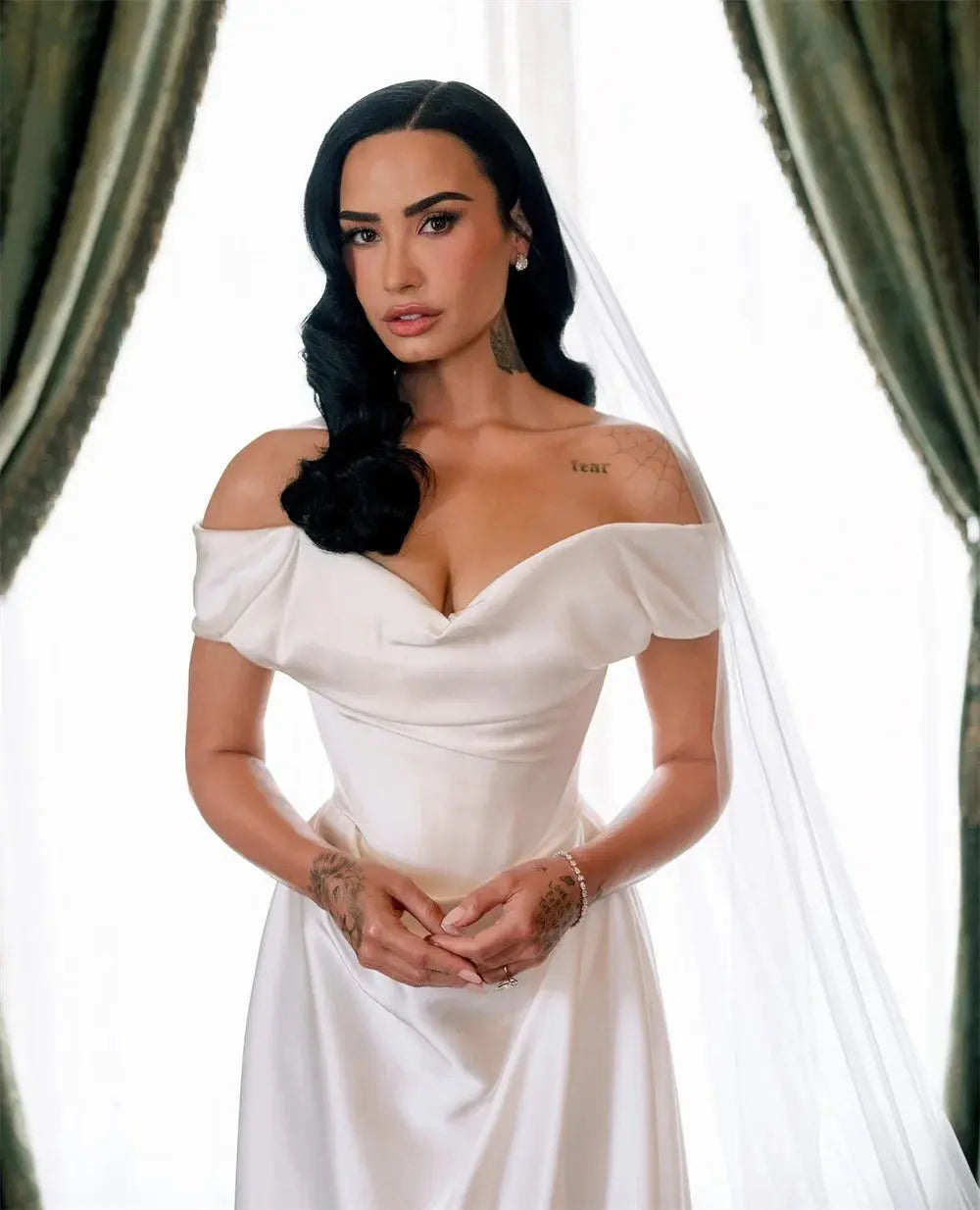Back view of the tailored bridal gown highlighting the graceful court train and sleek silhouette.