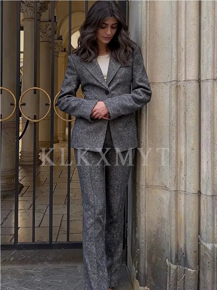 Model wearing the versatile black suit set, exuding confidence.