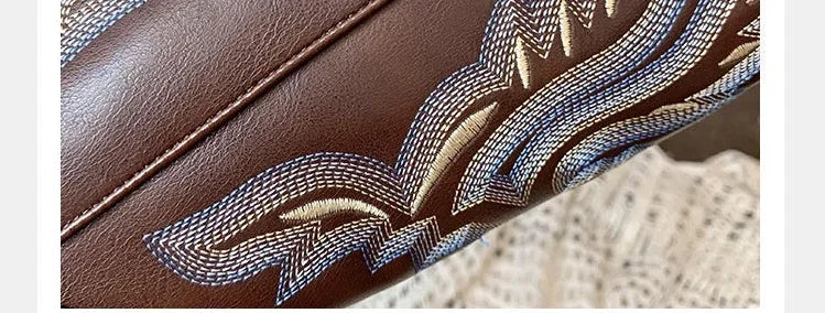 Leather Western boots featuring artisan-style embroidery and classic square toe silhouette