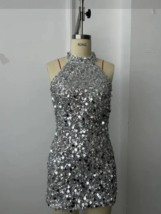 Model wearing a form-fitting sequin mini dress, highlighting its comfortable polyester fabric.