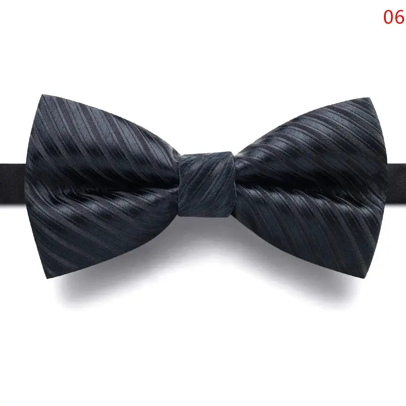 Close-up of the knot on the black bow tie, highlighting its effortless elegance.