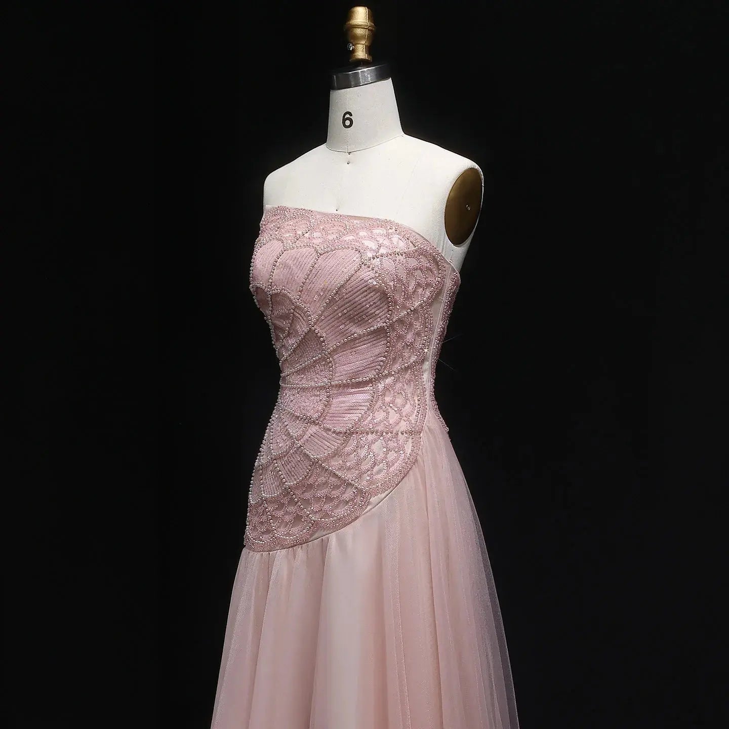 Flowing A-line silhouette of the gown showcasing a flattering natural waistline.