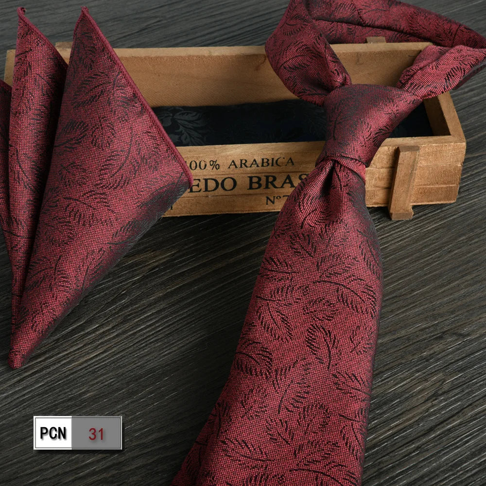 Wine-red tie and scarf set for a coordinated, elegant look.