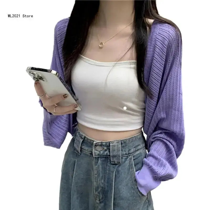Versatile navy cropped cardigan with an open front, enhancing any outfit with a stylish touch.