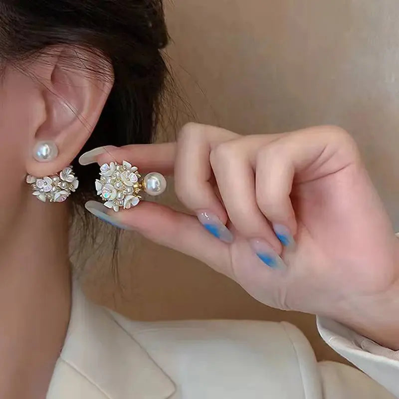 Elegant pearl earrings with modern spherical twist, perfect for weddings and special occasions.