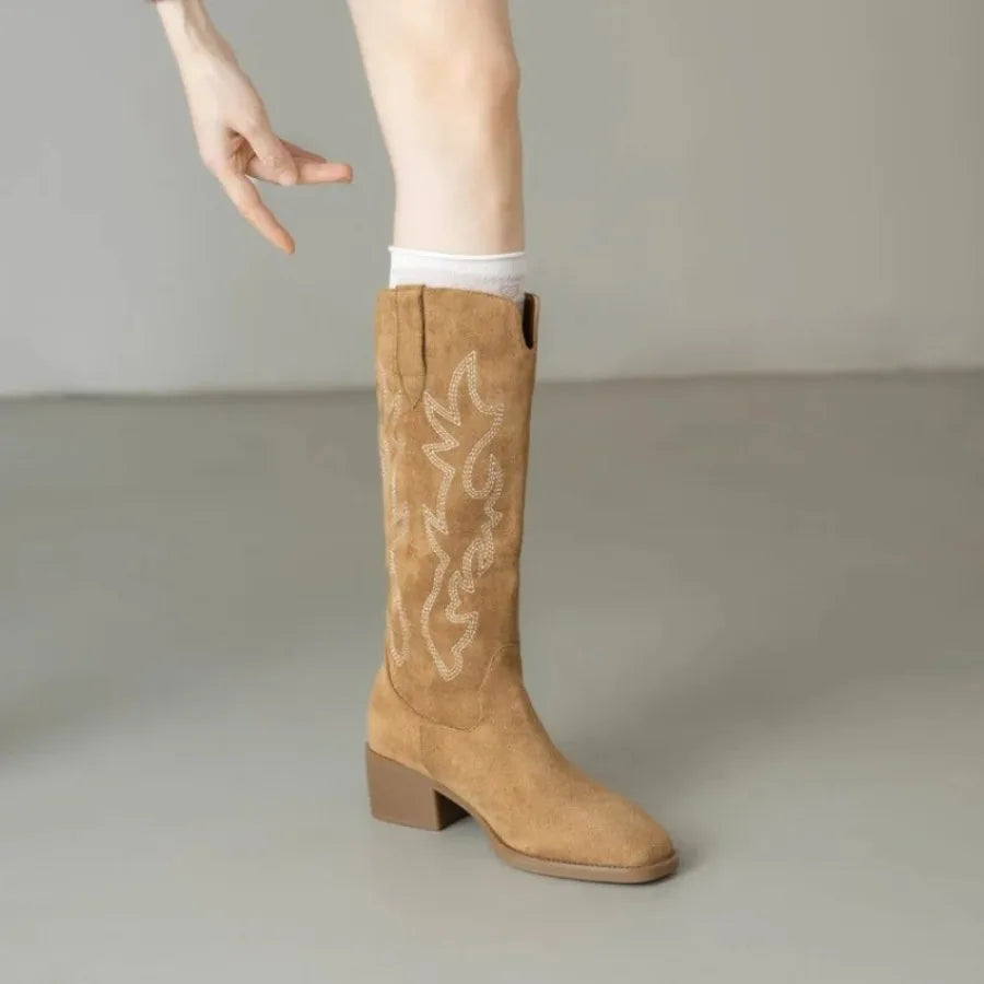 Women's brown leather cowboy boots featuring intricate embroidered patterns