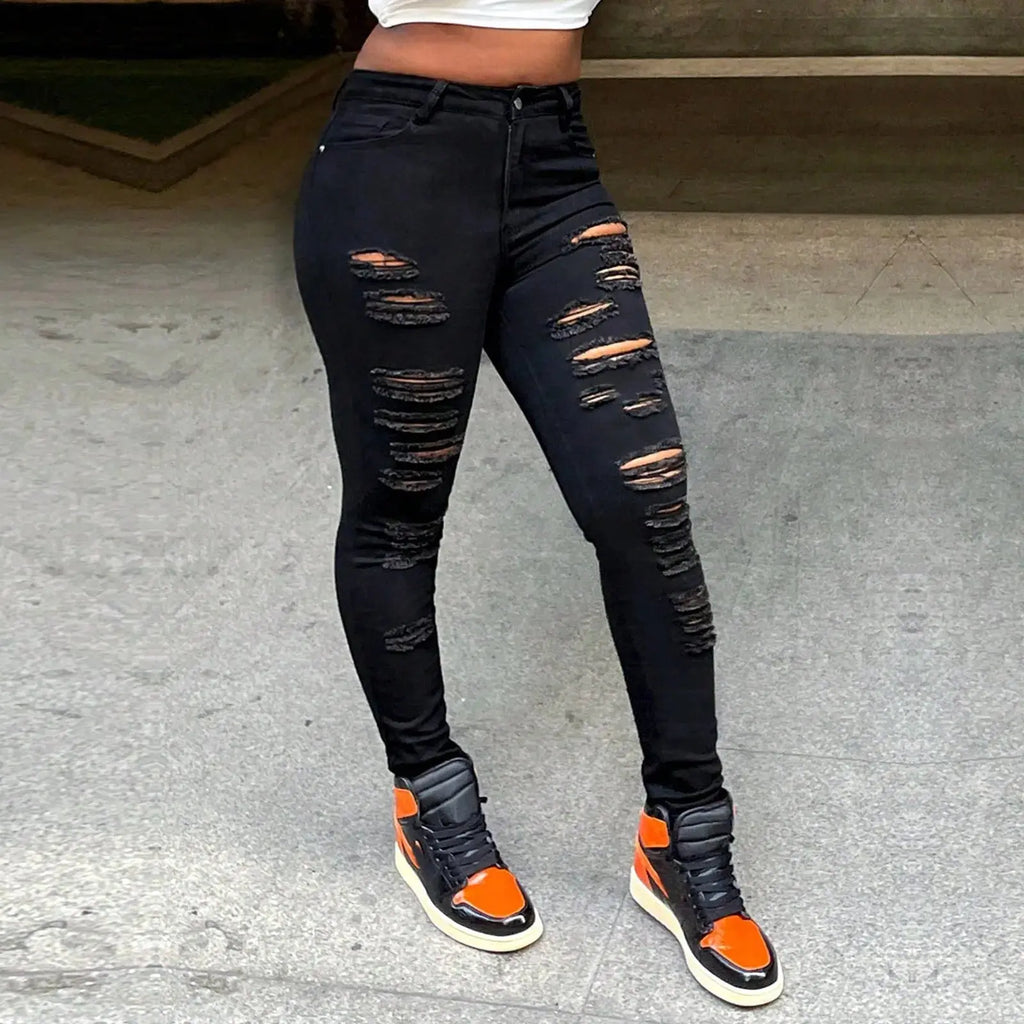Side profile of high-rise ripped jeans in deep black showcasing leg-lengthening fit and contoured waistline