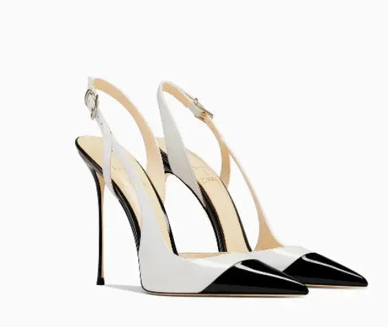 Sleek white patent leather heels with pointed toe and slim heel design.