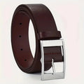 Close-up of the sleek design of the unisex leather belt with metal buckle.
