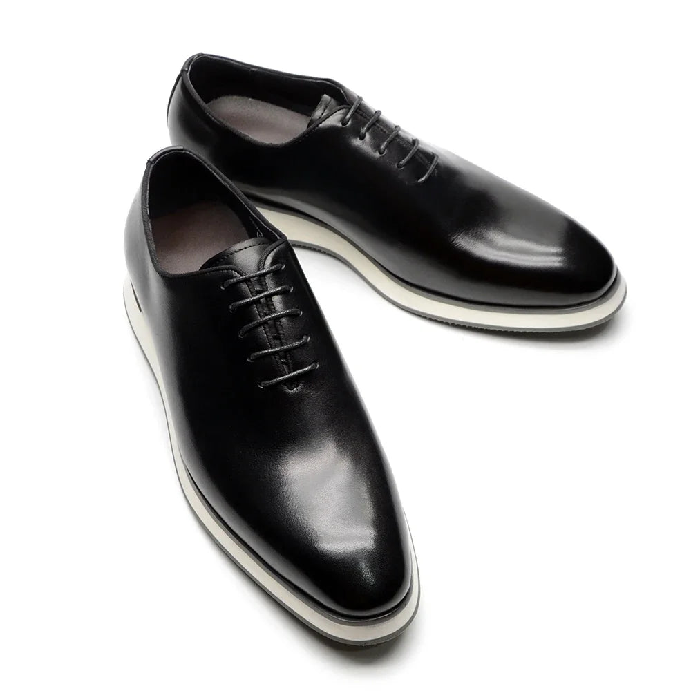 Premium whole-cut Oxford shoes crafted from single piece cowhide leather showing seamless construction detail