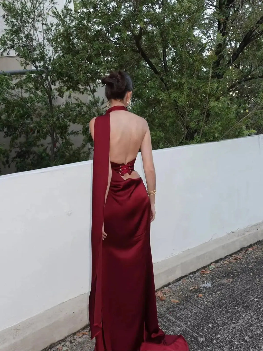 Burgundy satin evening gown with high-waist corset and mermaid tail design.