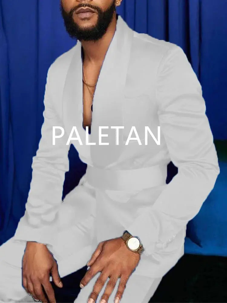 Model wearing royal blue tuxedo at a gala, capturing attention.