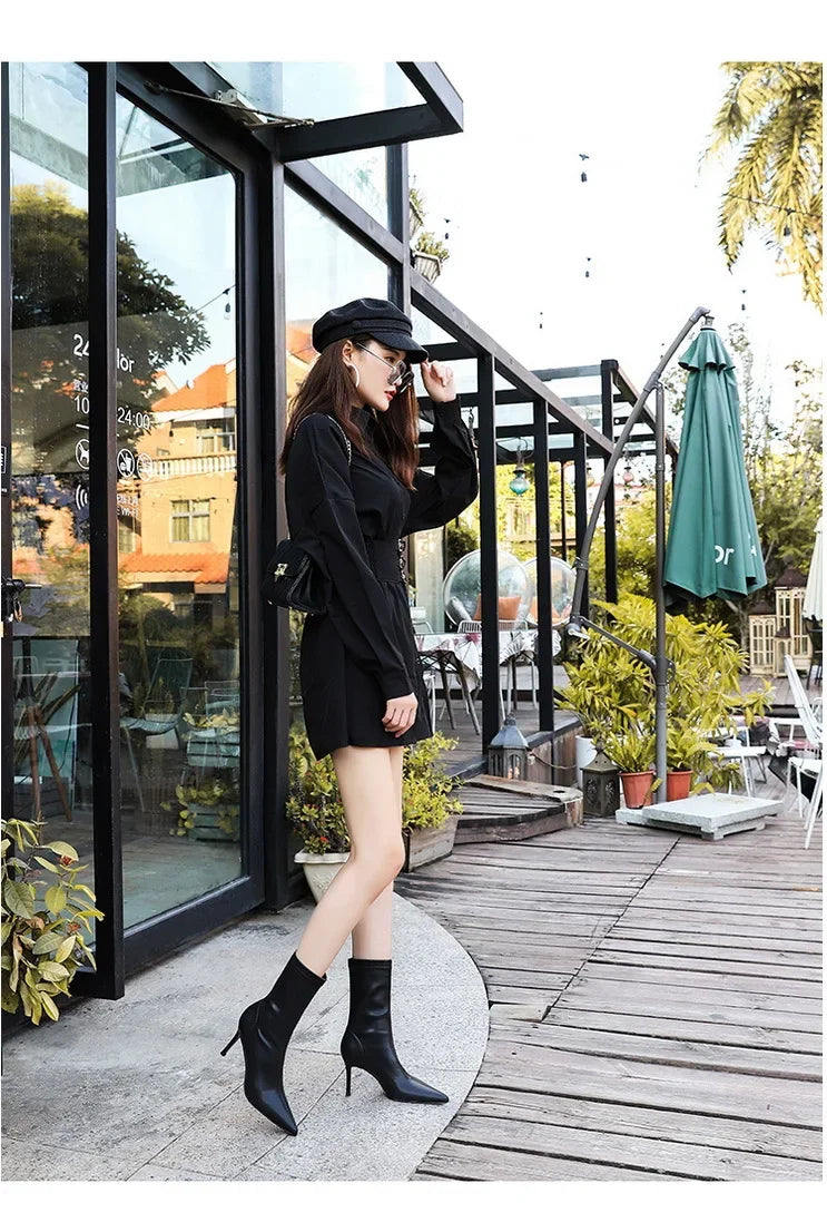 Timeless black leather boots featuring pointed toe and stiletto heel
