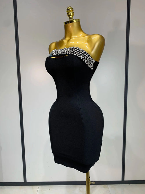 Close-up of intricate beading and diamond embellishments on the elegant mini dress.