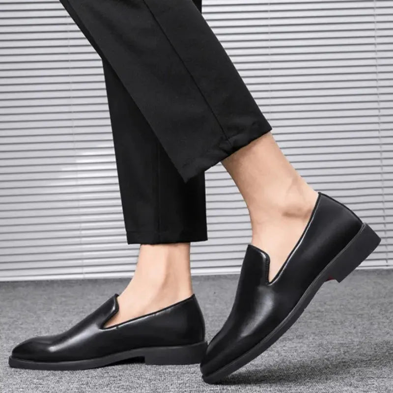 Classic black business loafers for men showcasing signature red sole and premium leather-look finish