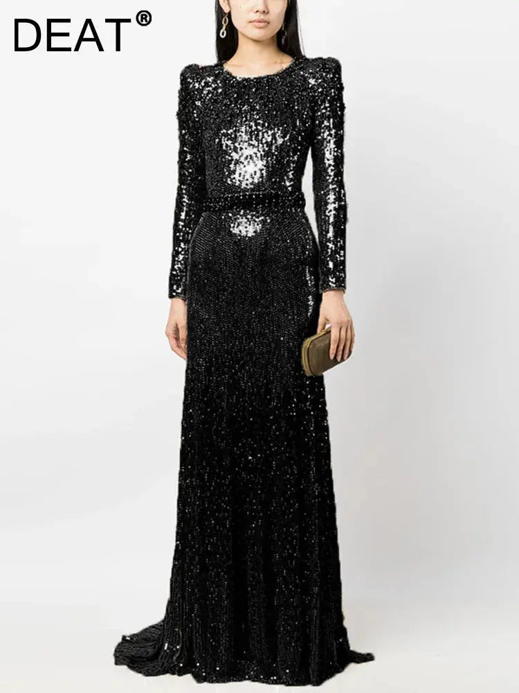Elegant floor-length sequined gown in deep navy, perfect for evening elegance.