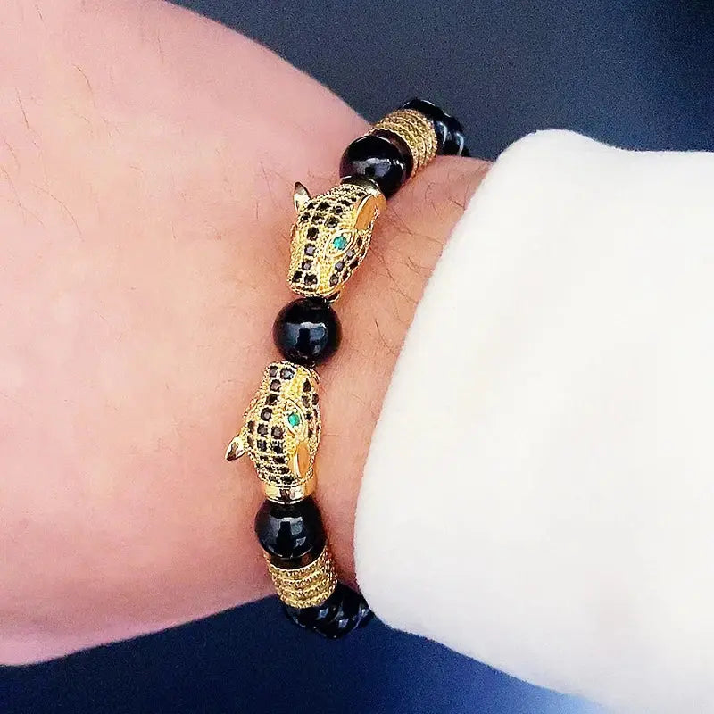 Close-up of the leopard charm on the beaded bracelet, showcasing intricate 18K gold plating.