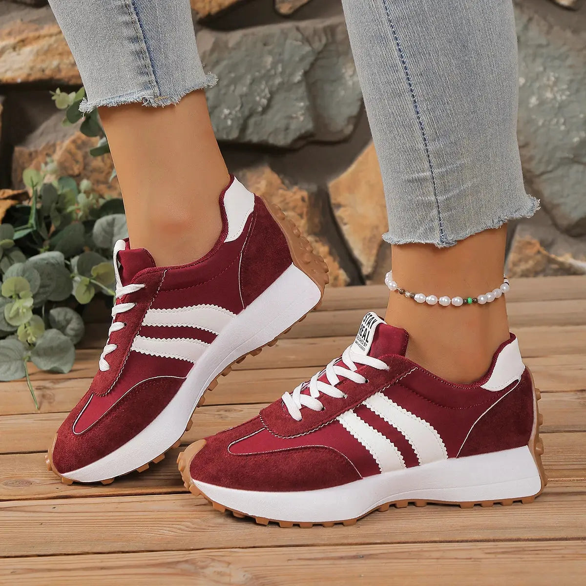 Fashionable maroon sneakers designed for all-day support and comfort.