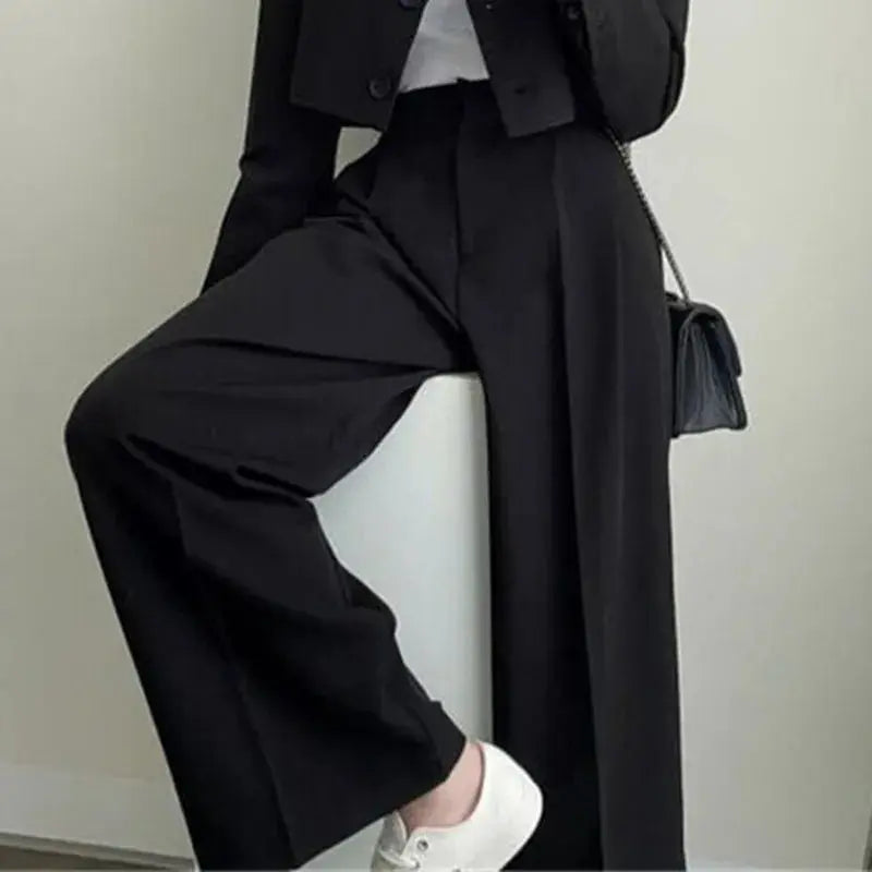 Model wearing the chic wide-leg power suit, exuding confidence in a corporate setting.