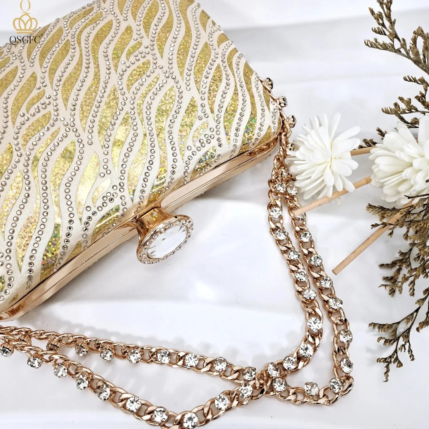 Elegant gold clutch with long chain shoulder strap for evening events.