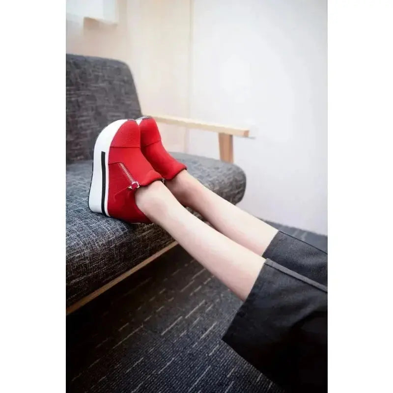 Model wearing red wedge sneakers, perfect for city walking.