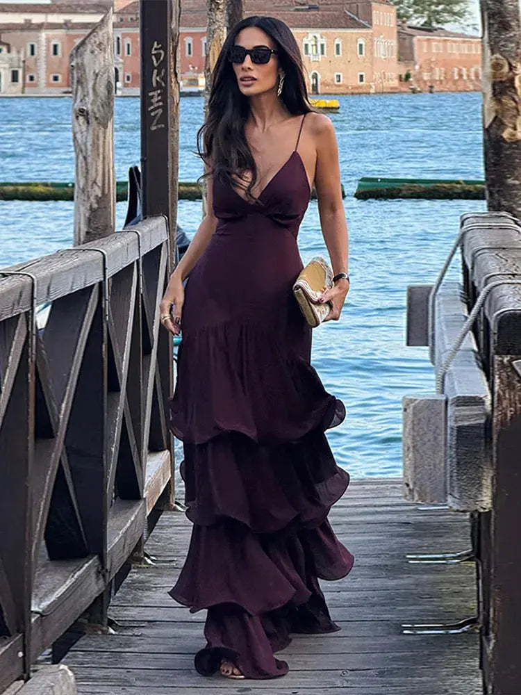 Flowing pleats of the halter gown create a dramatic silhouette for evening events.