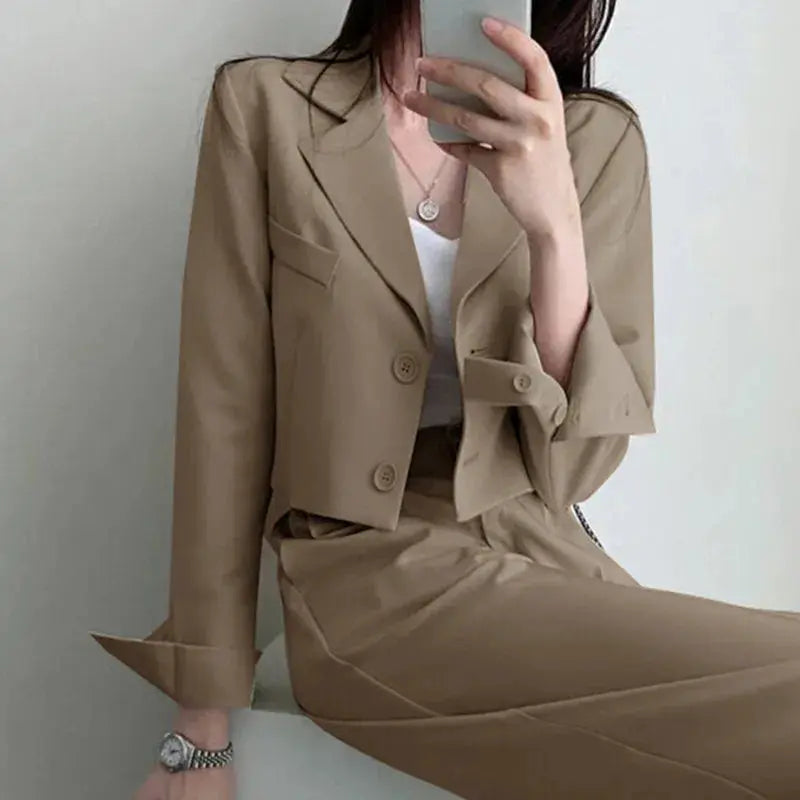 Detail shot of the high-waist pants, emphasizing the elongating silhouette of the suit.