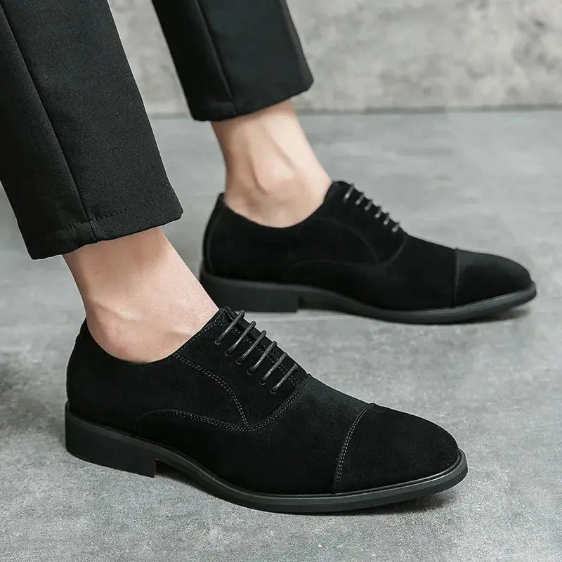 Side view of the tailored brown suede oxfords, emphasizing their sharp pointed toe and craftsmanship.
