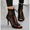 Elegant black mesh heels with ankle straps for starlit events.