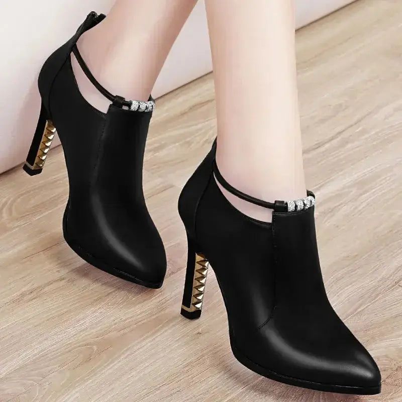 Detail shot of the luxurious PU leather on the red stiletto ankle boots.