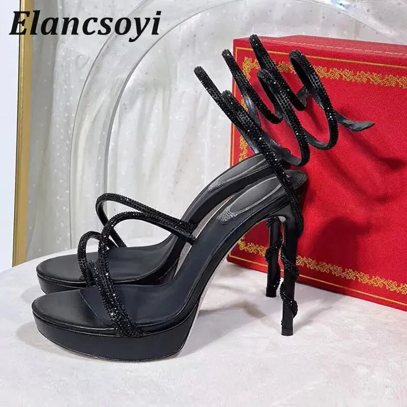 Black crystal-studded stiletto heels with a sleek silhouette and ankle strap.
