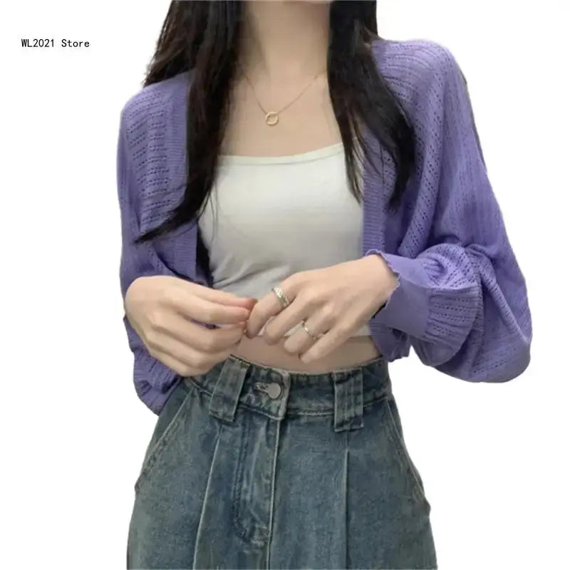 Light pink cropped cardigan with a soft texture, perfect for layering over high-waisted skirts.
