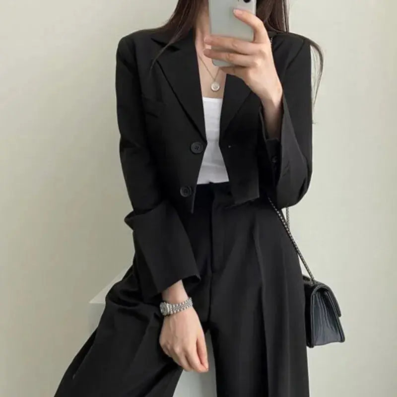 Tailored women's suit displayed in a bright office environment, showcasing its elegance.