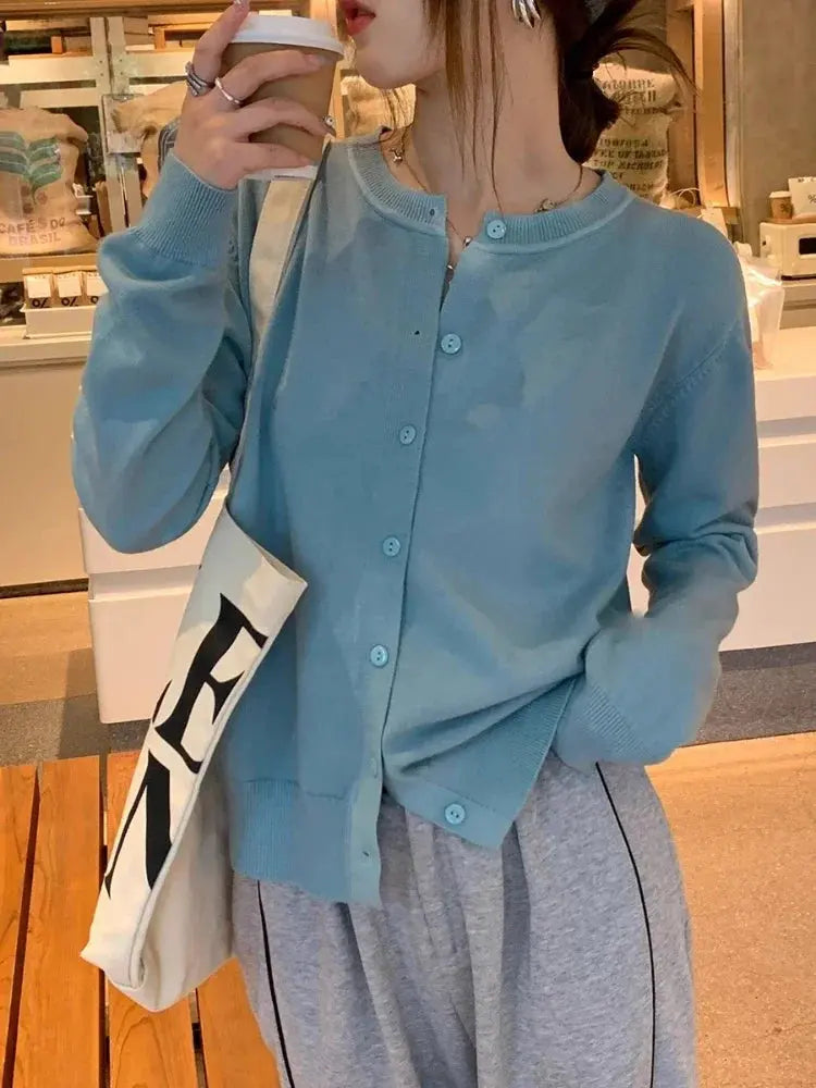 Flat lay of Cozy Chic Cardigan with accessories, showcasing its versatility in styling.
