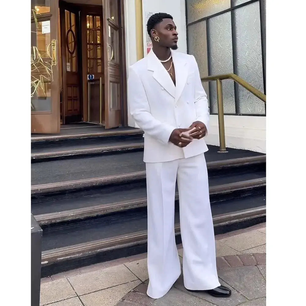 White double-breasted suit showcasing tailored precision and luxury fabric.
