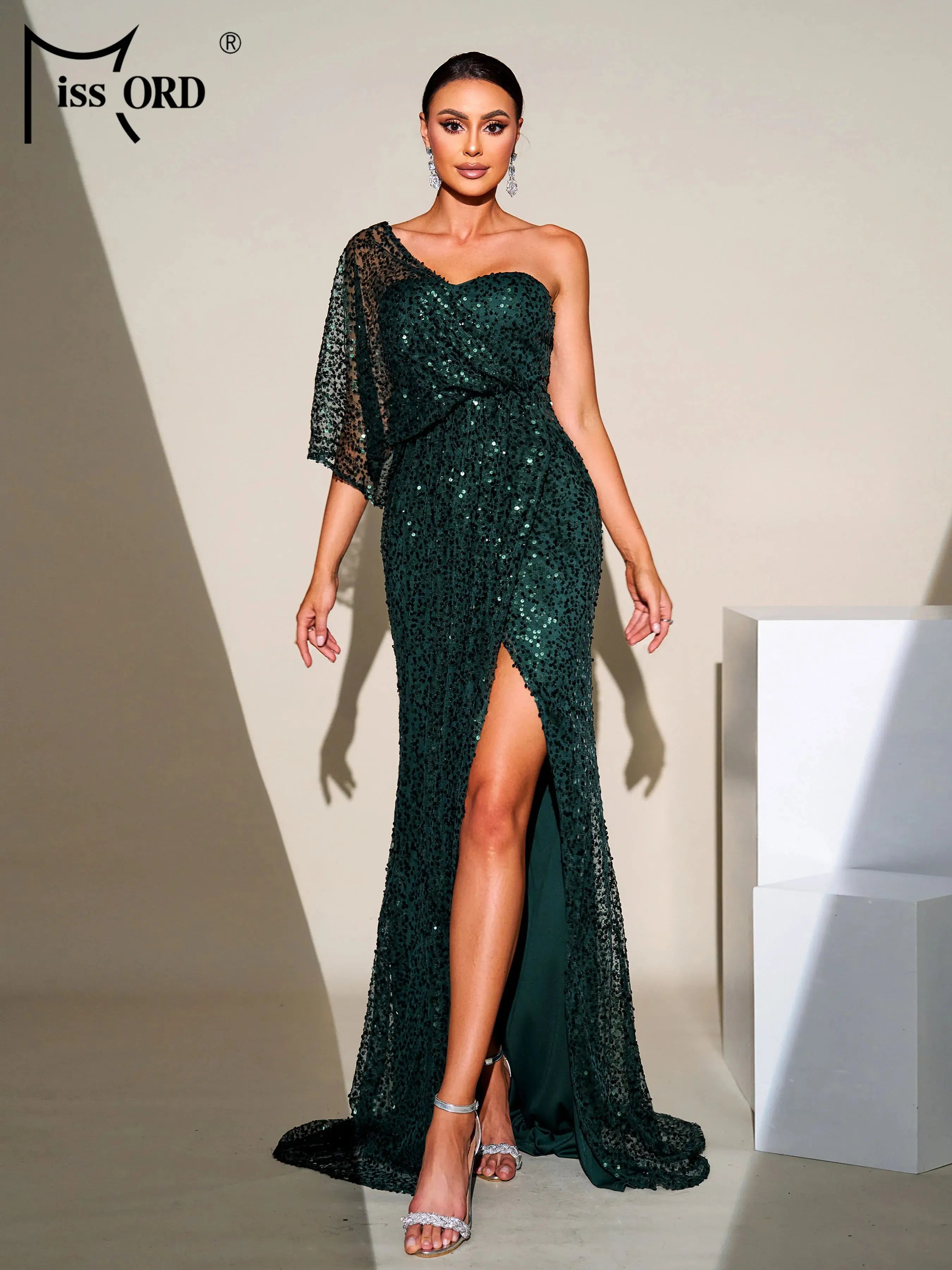 Model posing in the one-shoulder gown, exuding confidence and elegance.