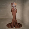 One-shoulder satin evening gown in elegant mermaid silhouette with delicate sequins and high neck design.