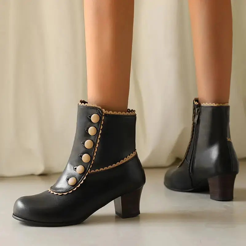 Side view of ankle boots showcasing the sturdy square heel and sleek design.