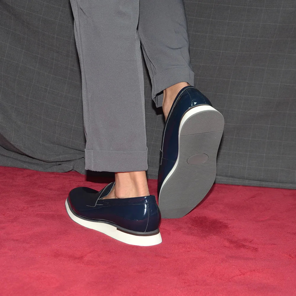 Wine-red patent loafers displaying executive polish and shine