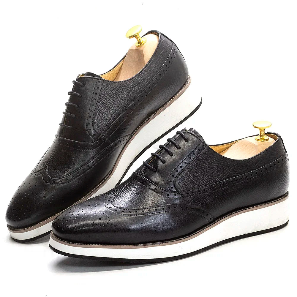 Artisan-crafted leather Oxford shoes featuring timeless wing tip design and quality stitching