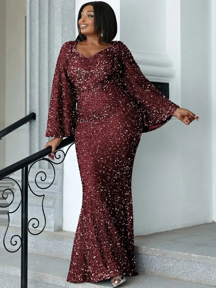 Dramatic trumpet sleeves of the sequin gown adding movement.