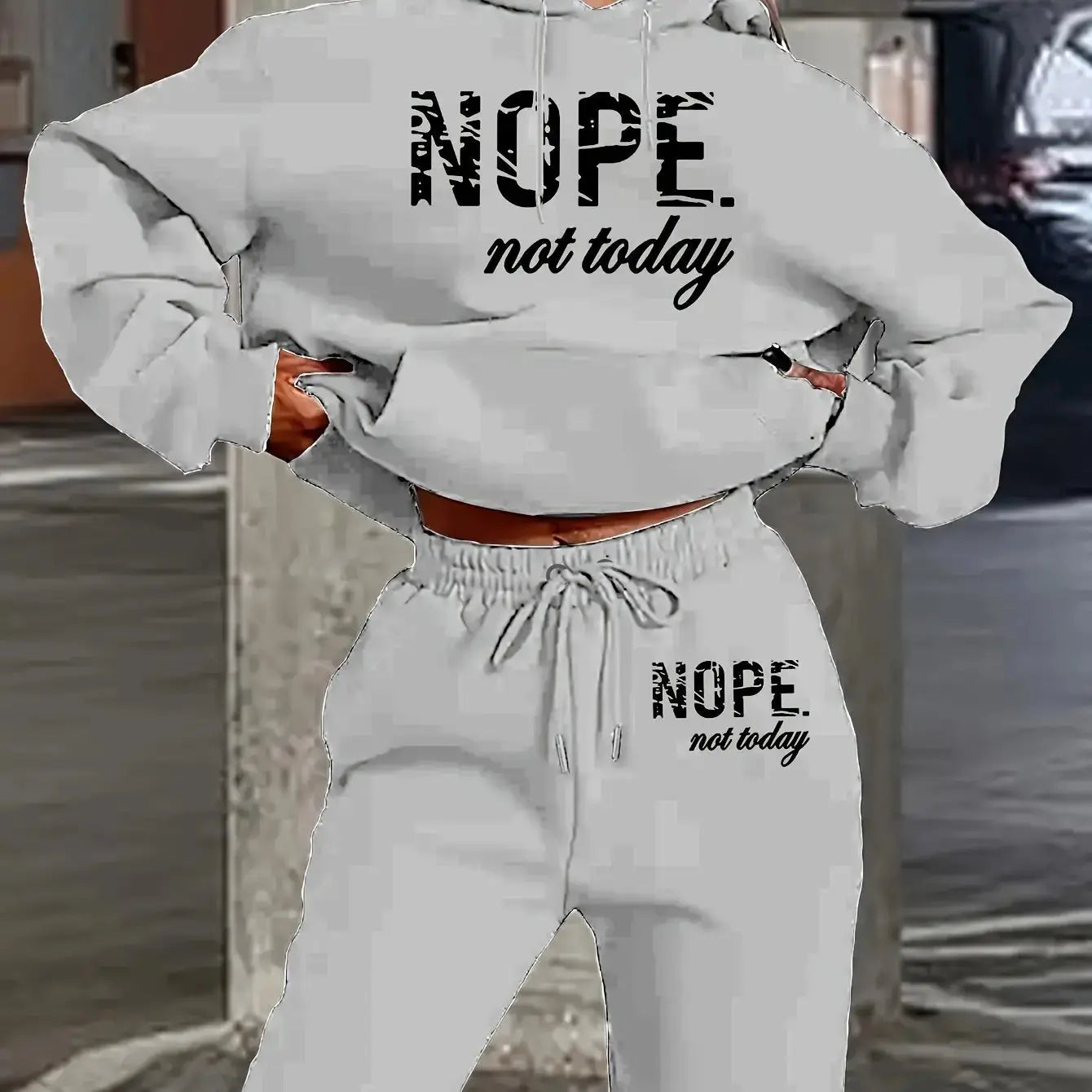 Coordinated black tracksuit set with hip hop inspired text graphics and relaxed silhouette