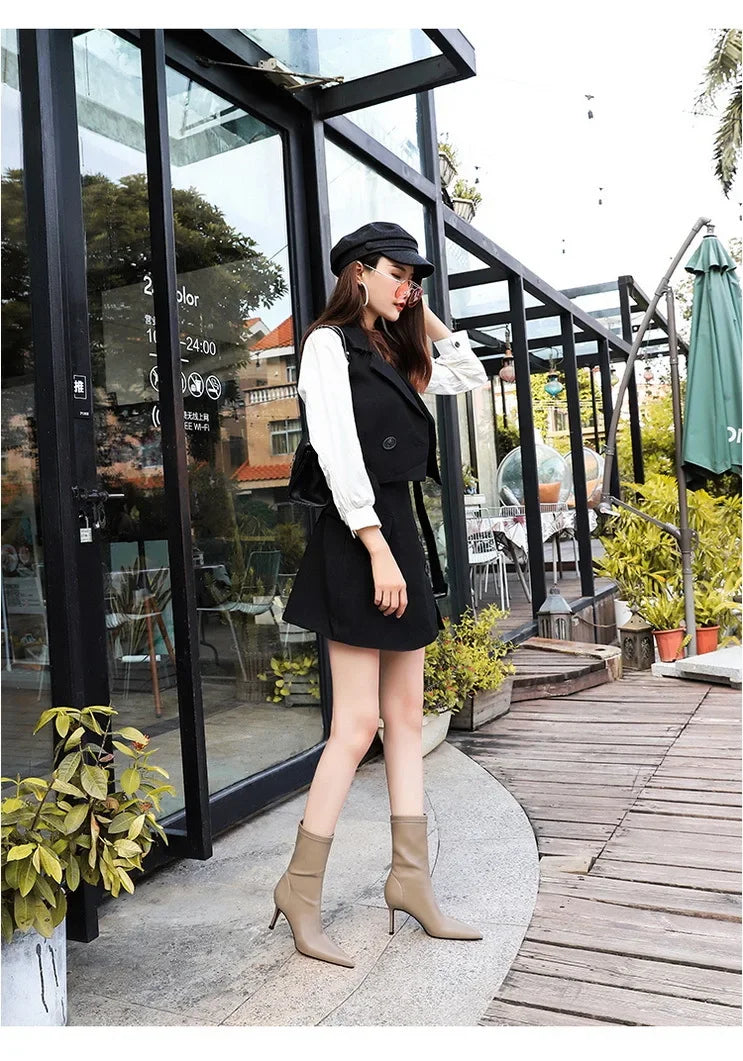 Elegant black leather boots with structured mid-calf silhouette