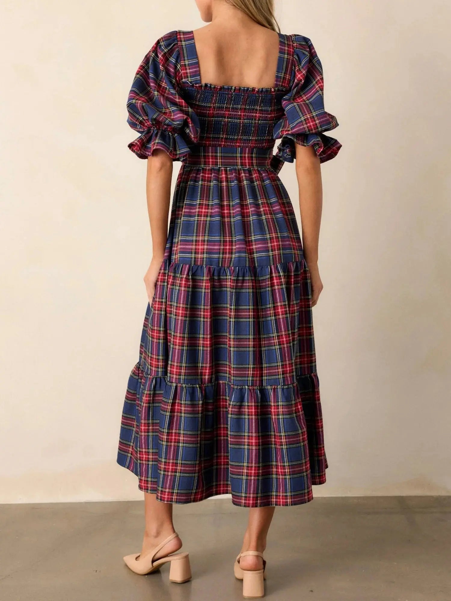 Whimsical bow detail on the Captivate in Plaid dress adds playful charm for holiday gatherings.