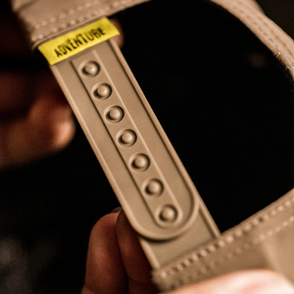 Side profile of structured baseball cap showing flat brim and embroidered lettering