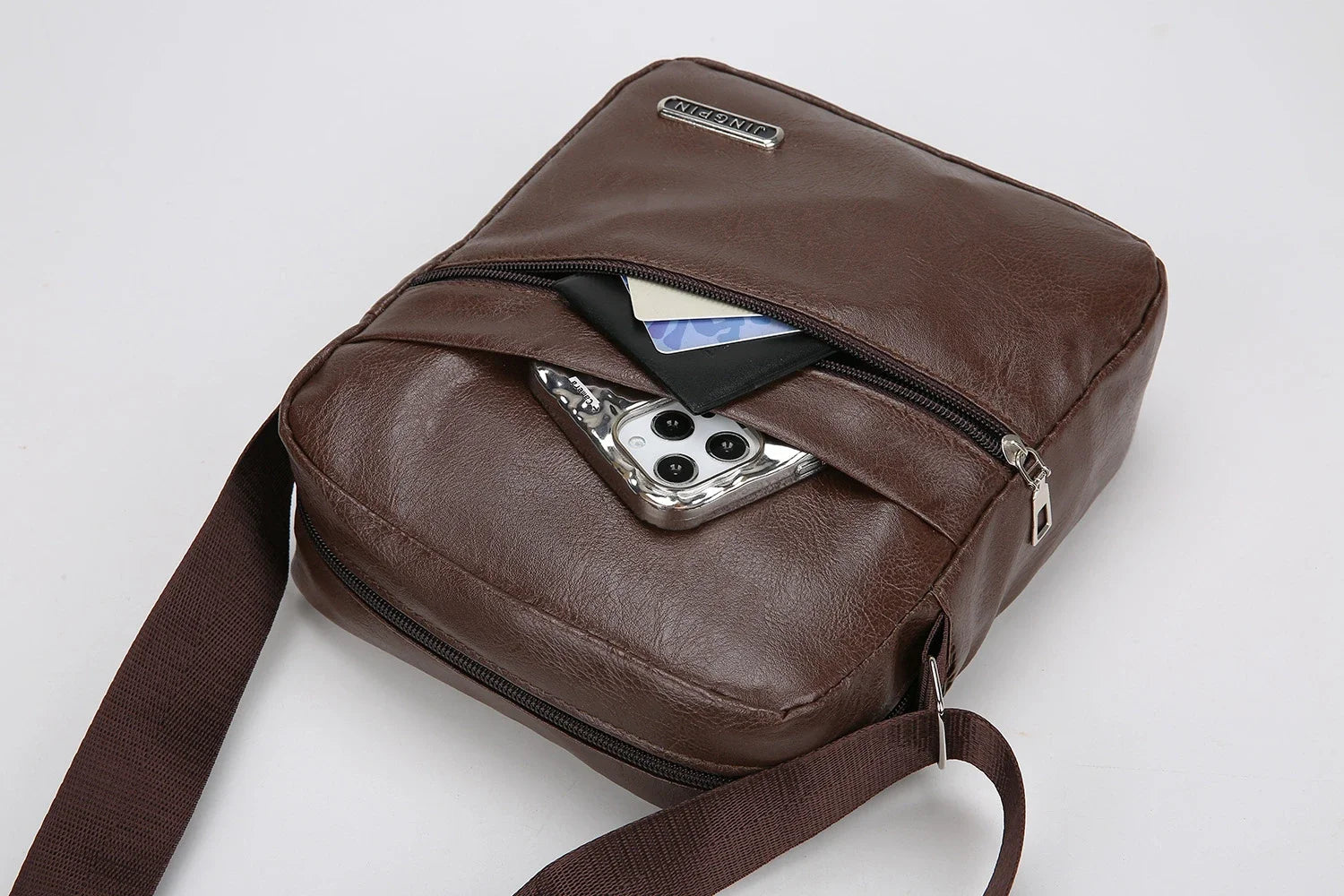Black messenger bag with smart compartments organizing devices and valuables efficiently