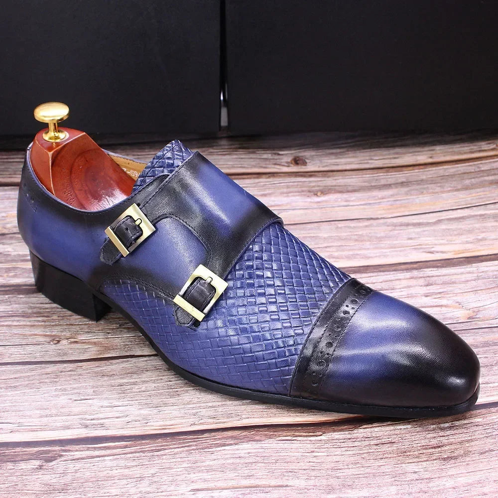 Elegant black monk strap shoes on a polished wooden floor.